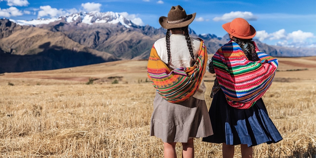 Quechua women in traditional dress pause in Sacred Valley