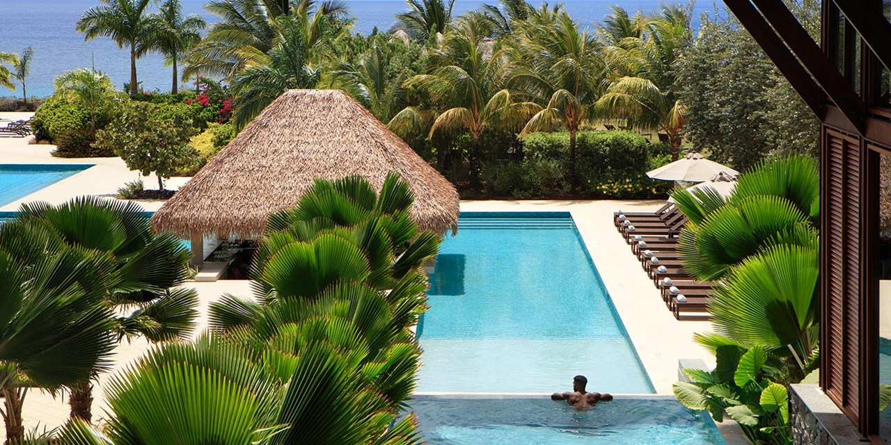 Relax beside the infinity pool overlooking the ocean