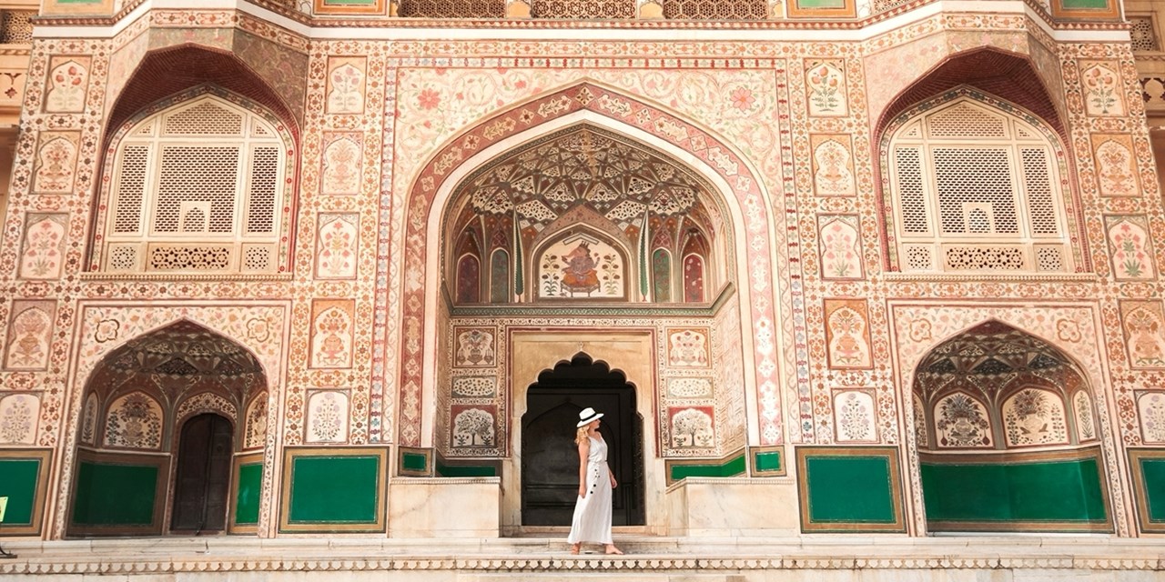 A visitor explores the ornate halls of Amber Fort in Jaipur