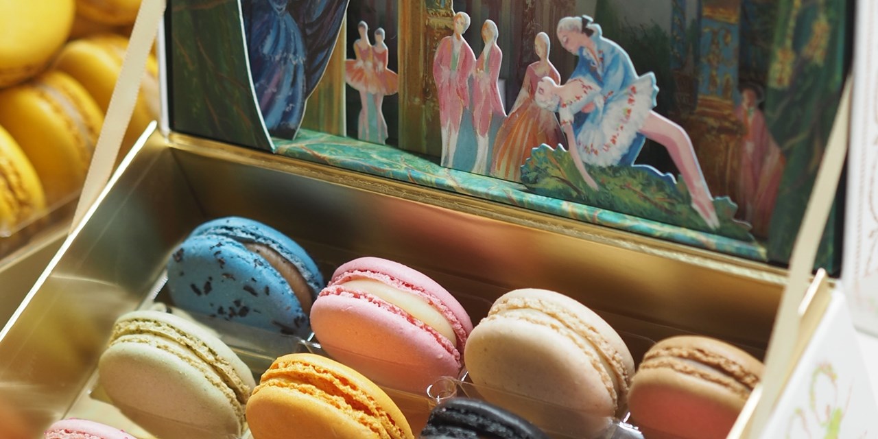 Colourful macarons fill a display case in Paris