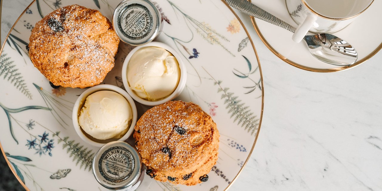 Enjoy tasty scones with jam and cream