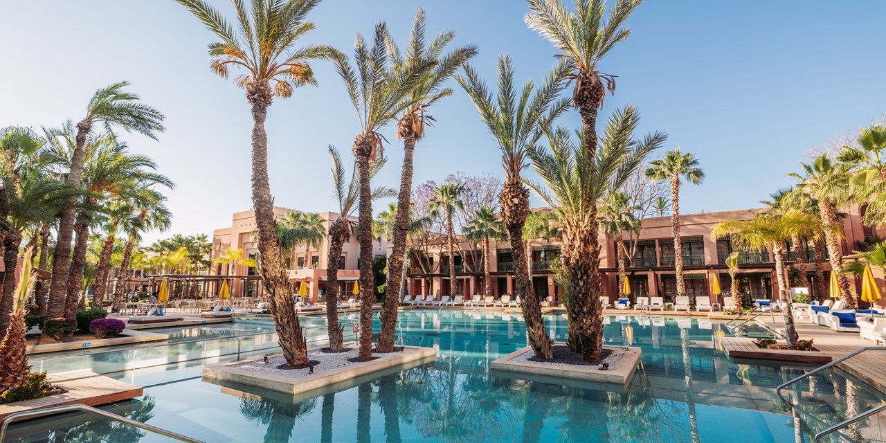 Find your favourite spot at the outdoor pool in the palm-dotted garden