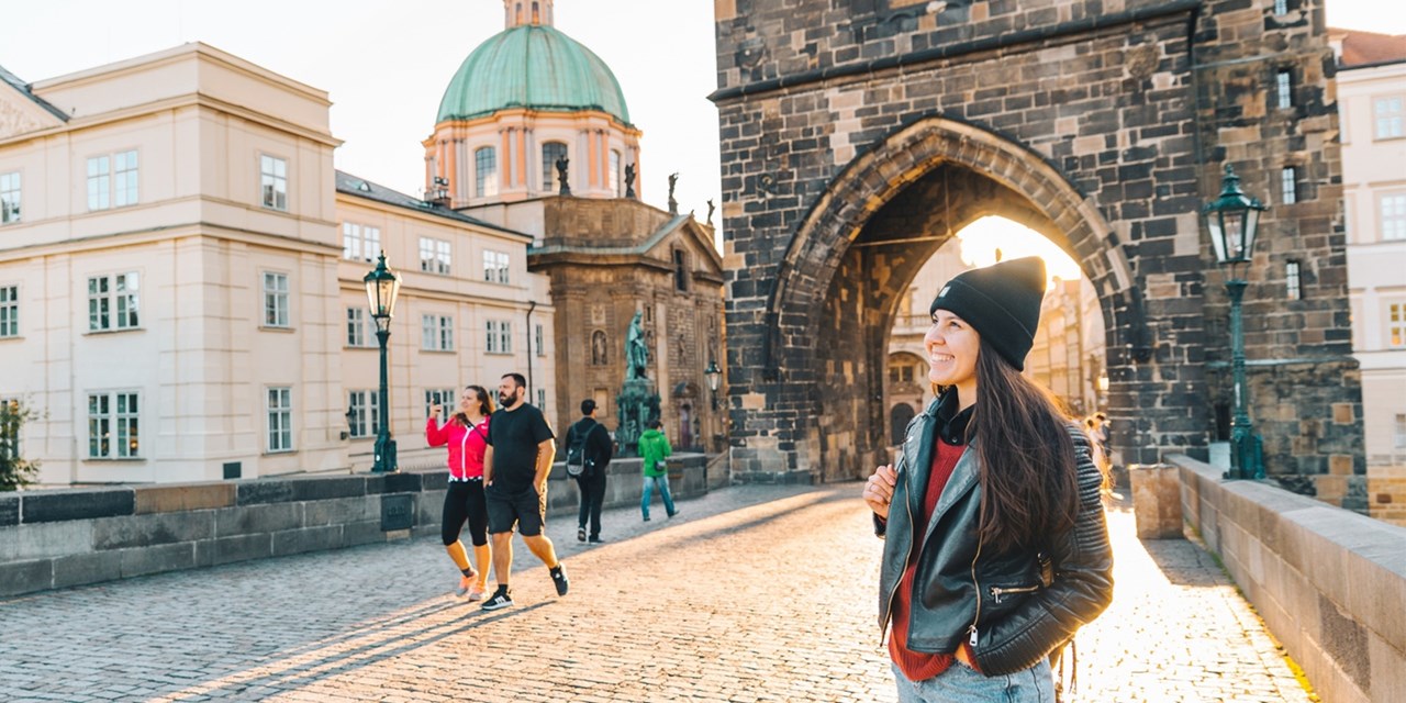 Cross the Vltava on the historic Charles Bridge