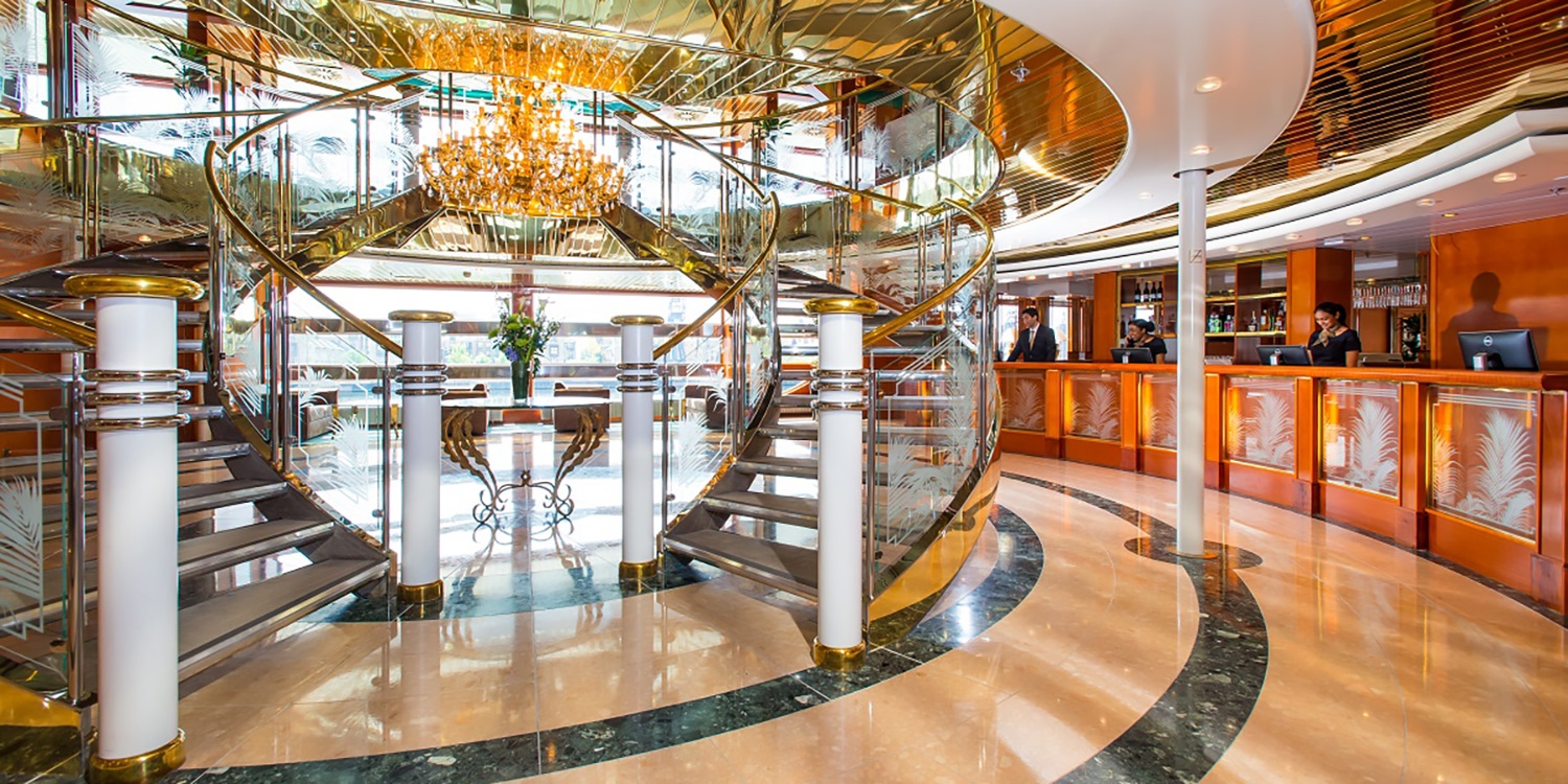 You'll be greeted by a grand staircase and chandelier upon entrance
